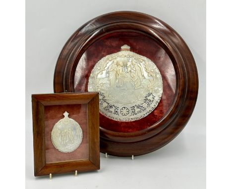 A Mother of Pearl carved nativity scene from Jerusalem in a mahogany circular glazed frame with a red velvet lining together 