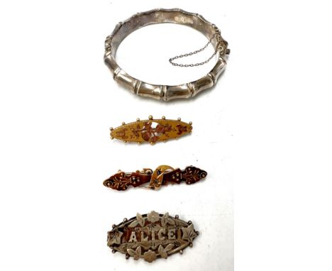 Hallmarked silver faux bamboo bangle, Alice brooch, 15 carat gold bar brooch set with sapphire and diamond, weight 2.7gm and 
