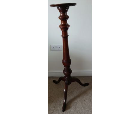 A mahogany torchère with turned column on tripod base.&nbsp;100cm h.