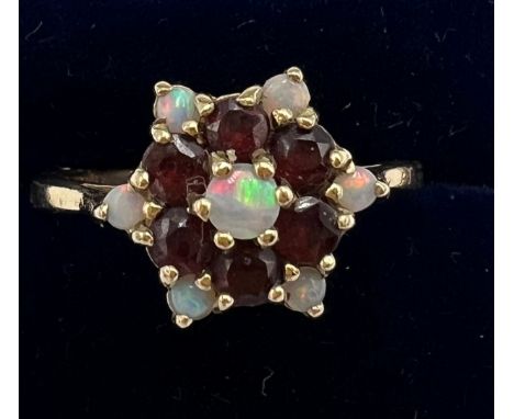 A 9 carat gold garnet and opal cluster ring. Size R, weight 3.6gm.