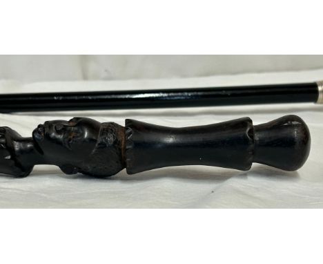 Two walking sticks, one with hallmarked silver collar Chester 1913 and an African stick with carved female head and serpent a