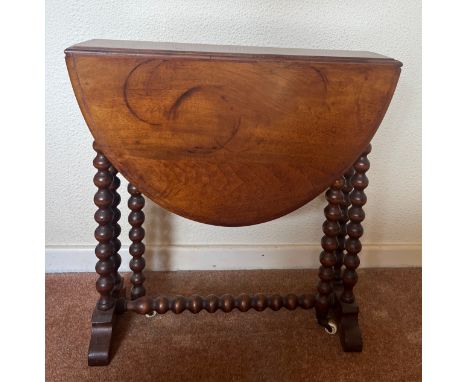 A 19thC mahogany Sutherland table with bobbin turned supports on ceramic casters. 73cm open x 57cm d x 56cm h.