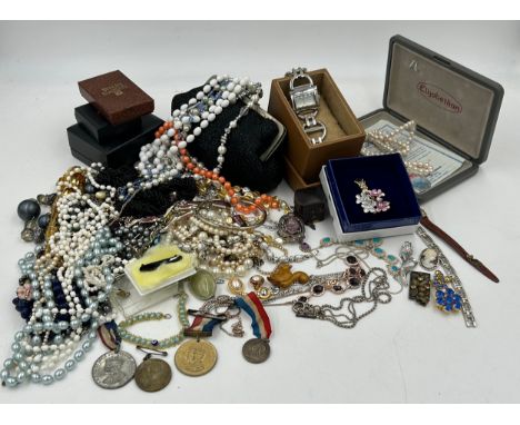 A quantity of costume jewellery to include  brooches, earrings, necklaces, a Michael Kors watch with box, a boxed Elizabethan