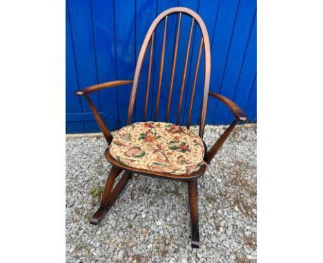 An Ercol rocking chair with original blue paper label.