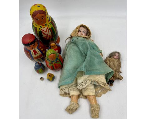 Armand Marseille bisque headed doll with sleeping eyes, a small bisque headed dolls house doll, vintage nesting dolls and a s