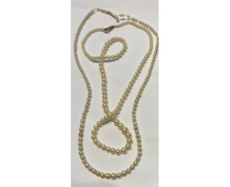 Two faux pearl single strand necklaces, one with an 18 carat clasp the other with a 9 carat gold clasp.
