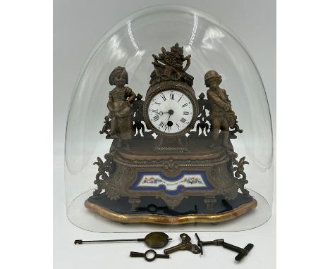 A French metal mantel clock with painted porcelain panel together with an un-associated glass dome 38cm h.