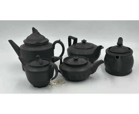 A group of early 19th century black basalt engine turned teapots and covers, one with dog finial c. 1810. Including two marke