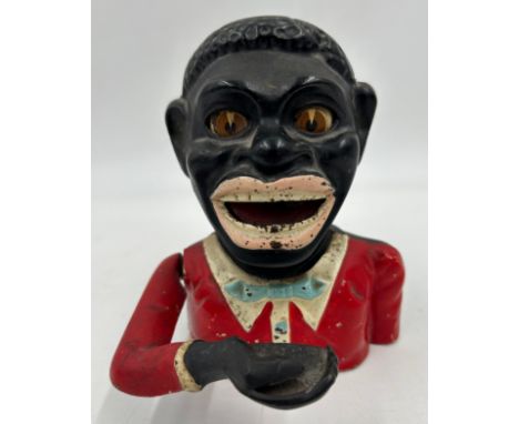 A vintage novelty greedy boy cast money box, in working condition. 15cm h. Notice from the the-saleroom.com: These items are 
