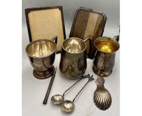 Hallmarked silver to include three mugs, two photograph frames, shell caddy spoon, Mordan Everpoint propelling pencil and two