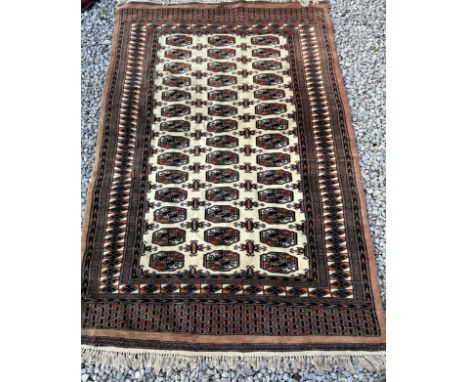 A cream ground wool carpet. 188 l x 125cm w without tassels.