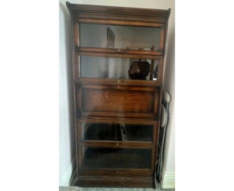 An oak five section globe wernike style bookcase, four glazed sections and one solid door with fitted sections to interior. 1