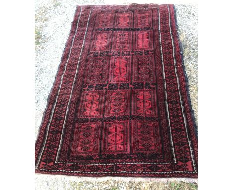 Oriental carpet, predominantly red, label to reverse 'made in Iran 195 x 113'.  192 l x 102 w without tassels.
