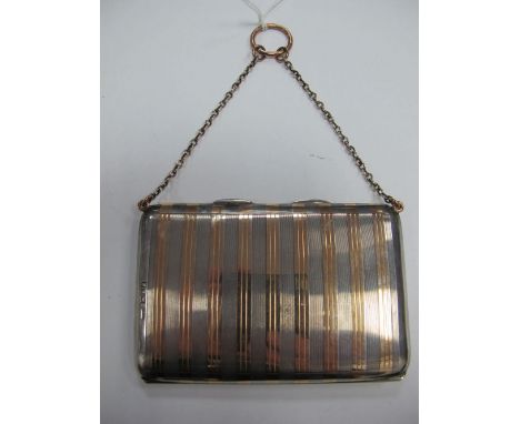 A Hallmarked Silver Card Case, of slim rectangular two colour design, engine turned, with spring hinge, on chain suspension w