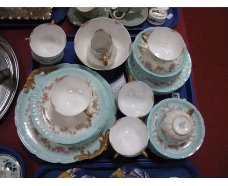 A Limoges Part China Tea Service, printed floral swags on a powder blue border, comprising ten cups, twelve saucers, twelve t