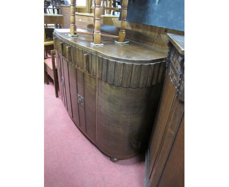 1930's Oak Bow Fronted Sideboard, with low back, segmented front drawers, over four cupboard doors, on bulbous feet.