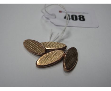 A Pair of 9ct Gold Cufflinks, each oval panel engine turned, on chain connections. 