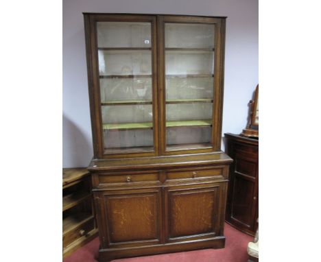 Early XX Century Oak Bookcase, with a glazed top, adjustable shelves, base with two small drawers, over panelled cupboard doo