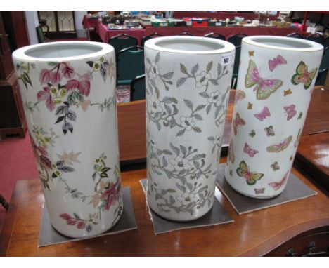 Three Ceramic Original Stick Stands, of cylindrical form decorated with butterflies and foliage.