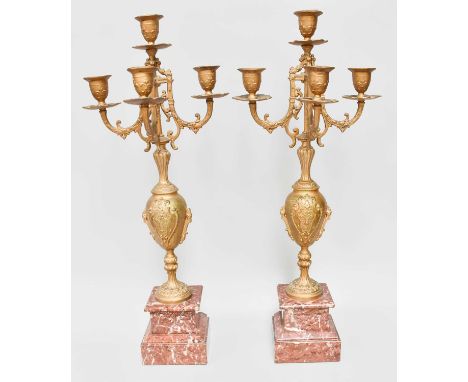 A Pair of Rouge Marble and Gilt Metal Four Light Candelabra, of urn form and on stepped plinths, 55cm (2)