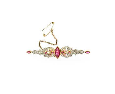 A Ruby and Diamond Brooch, of tapered form, the central marquise cut ruby flanked by round cut rubies in yellow millegrain se