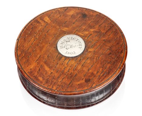 A VICTORY OAK SNUFF BOX, EARLY 19TH CENTURYthe circular oak box with a silver plate engraved H.M.S. 'Victory' 21st October 18