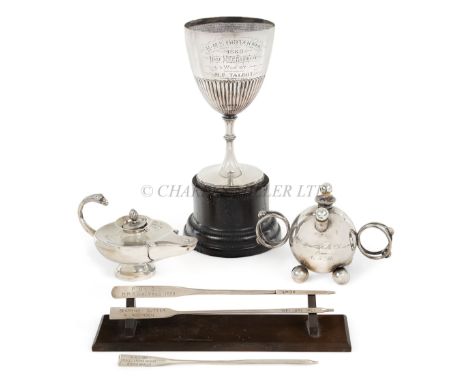 A COLLECTION OF NAVAL SILVERWAREcomprising a sports trophy from H.M.S. Britannia 1888; a bombe-form cigar lighter from the Wa