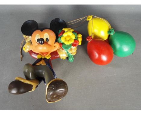 Walt Disney, Mickey Mouse - An scarce papier mache figure of Mickey Mouse holding a bunch of flowers and hanging onto three b
