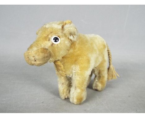 Steiff - An unboxed vintage Standing Blonde Ox Bull probably by Steiff. The unmarked and untagged mohair bull with glass eyes