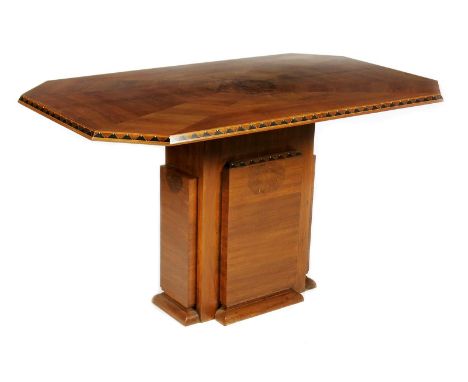 λ An Epstein style Art Deco inlaid walnut veneer dining table, the chamfered rectangular top inlaid with ebonised wood and iv