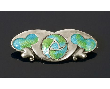 An Art Nouveau silver and enamel bar brooch, cast in low relief with heart-shaped foliage and central roundel, enamelled turq