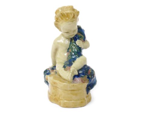 Buster Boy a Hammersmith Bridge stoneware figure by Phoebe Stabler, dated 1913, modelled, glazed in colours on a buff ground,