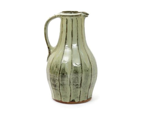 Jim Malone (born 1946) an Ainstable Pottery stoneware cut-sided tall ewer, covered to the foot with an ash glaze, impressed s