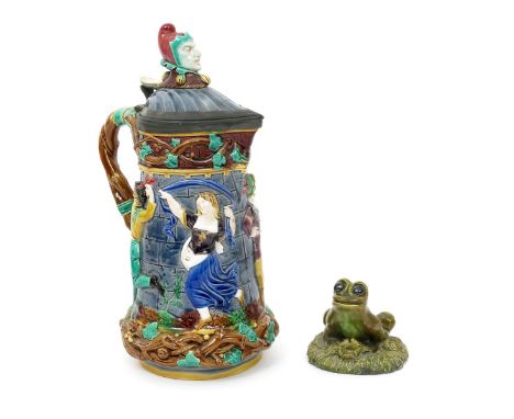 A Minton majolica jug with hinged cover, model no.1231, modelled in relief with medieval dancing figures, glazed in colours, 