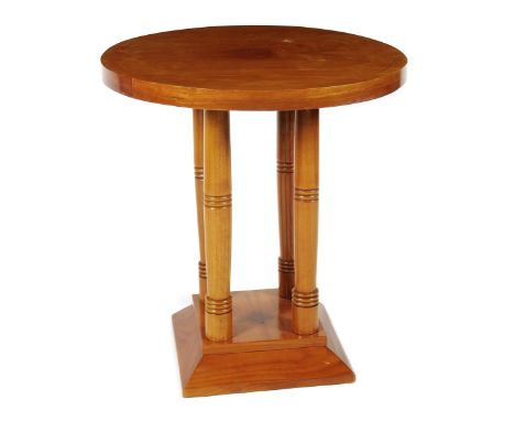 An Art Deco veneer occasional table, on four turned legs, circular top with simple marquetry tracery decoration, on flaring s