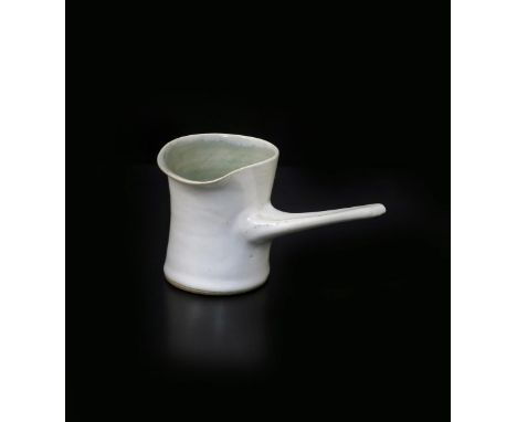 ‡ Dame Lucie Rie DBE (1902-1995) a stoneware pourer with pulled side handle, covered in an off white glaze, the interior pale