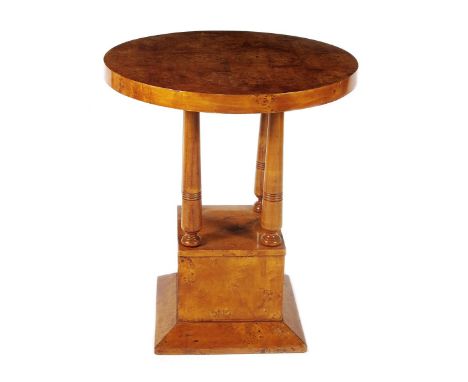 An Art Deco Burr-walnut occasional table, the square plinth supporting four turned pedestal legs and circular top, unsigned, 