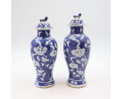 Pair of Chinese Prunus pattern temple jars with Fu dog finials to lids, H: 28cm. Restoration to one of the lids, nibbles to t