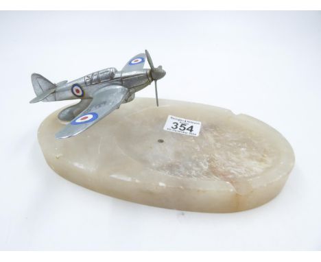 Aluminium Spitfire mounted on an onyx ashtray base, L: 25cm. UK P&amp;P Group 2 (£20+VAT for the first lot and £4+VAT for sub