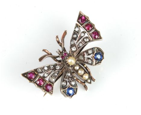 An Edwardian 9ct gold, silver, sapphire, ruby, pearl and diamond butterfly pendant brooch - the butterfly's body set with gra