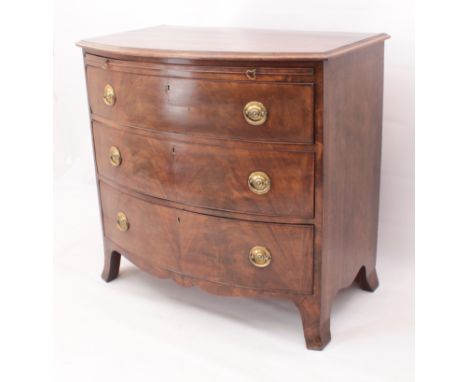 A bowfront mahogany chest of drawers -&nbsp;early 19th&nbsp;century,&nbsp;moulded top over a brushing slide, three long drawe