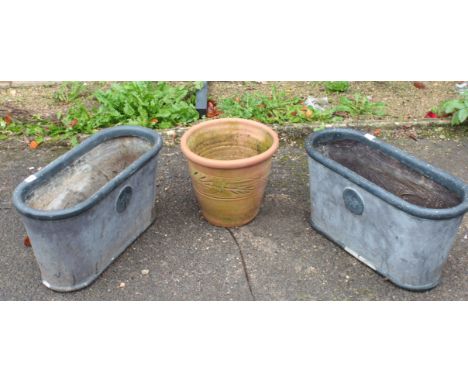 A pair of fibreglass planters; together with a terracotta plant pot. (3)