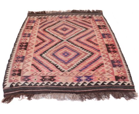 An Afghan kilim rug&nbsp; first half 20th century, with two stepped lozenges in shades of terracotta, dark blue, dark brown a