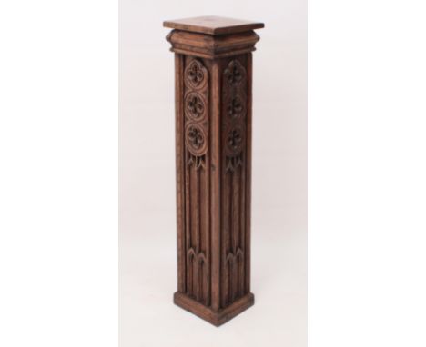 A carved oak pedestal in the reformed Gothic taste - early 20th century, probably originally a corner post from a church scre