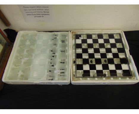Two chess boards boxed with shot glasses