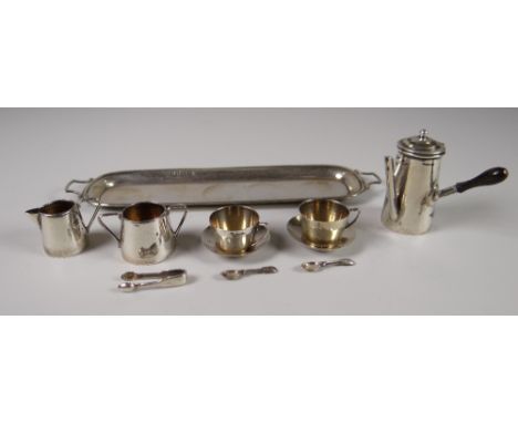 A RARE MINIATURE SILVER HOT-CHOCOLATE SET including conforming tray, tapered chocolate-pot, two cups and saucers, twin-handle