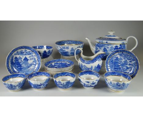 AN EARLY NINETEENTH CENTURY BLUE AND WHITE WILLOW PART TEA SET with gilt rim and including teapot, bowls, tea-bowls, cream ju