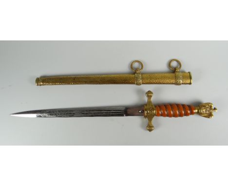 A GERMAN KRIEGSMARINE DAGGER with beaten effect yellow metal scabbard, yellow metal finial and cross-guard with centred ancho