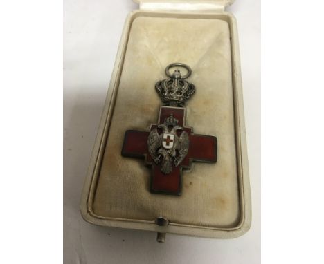 A Serbia Order of the Red Cross decorated with enamel and with the date 1876. In a fitted case.