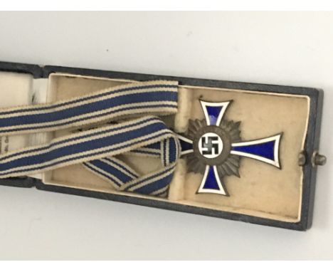 A German third Reich enamel cross in a fitted case dated 16th December 1938